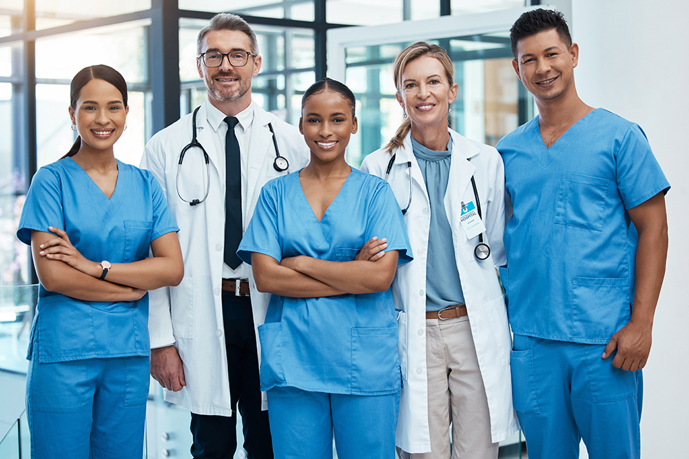Happy doctors and nurse smile at a hospital with support, teamwork and collaboration with diversity. Team of expert medical professionals smiling at work together at clinic in the healthcare industry